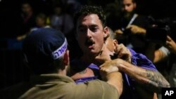 Police forcibly detain an Israeli protesting against plans by Prime Minister Benjamin Netanyahu's government to overhaul the judicial system, in Tel Aviv, July 20, 2023.