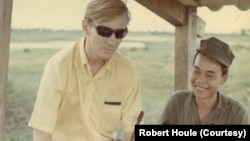 Bob Houle stands guard with a South Vietnamese fighter in 1968. 