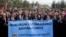 People, mostly lawyers, hold a banner that reads in Turkish, "We defend the supremacy of law," during a protest called by the Union of Turkish Bar Associations, in Ankara, Nov. 10, 2023.