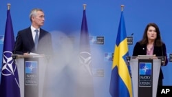 Sweden's Foreign Minister Ann Linde, right, speaks at a media conference with NATO Secretary General Jens Stoltenberg at NATO headquarters in Brussels, Jan. 24, 2022. 
