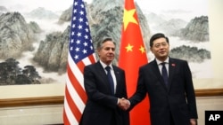 FILE - US Secretary of State Antony Blinken shakes hands with Chinese Foreign Minister Qin Gang, at the Diaoyutai State Guesthouse in Beijing, June 18, 2023. 