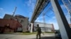 FILE - A Russian serviceman guards the Zaporizhzhia Nuclear Power Station in southeastern Ukraine, May 1, 2022. Power was restored at the plant Saturday after it was lost Friday, averting a "nuclear catastrophe," said Ukraine's energy ministry.
