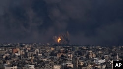Fire and smoke rise following an Israeli airstrike, in Gaza City, Oct. 8, 2023. 