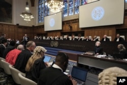 Judges and parties sit during a hearing at the International Court of Justice in The Hague, Netherlands, Jan. 12, 2024.
