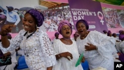 FILE - Women sing and dance during the International Women's Day celebration at the Mobolaji Johnson Stadium in Lagos, Nigeria, March 8, 2023. 