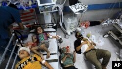 Palestinians wounded in the Israeli bombardment wait for treatment in Shifa Hospital in Gaza City Oct. 23, 2023.