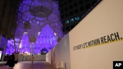A sign near Al Wasl Dome at Expo City reads 'Let's keep 1.5 degrees Celsius within reach' at the COP28 U.N. Climate Summit, Dec. 1, 2023, in Dubai, United Arab Emirates. 