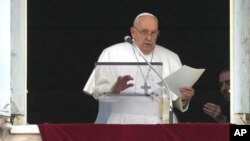 Pope Francis reads his message during the Angelus noon prayer from the window of his studio overlooking St. Peter's Square, at the Vatican, March 10, 2024.