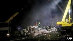 This handout photograph taken and released by the State Emergency Service of Ukraine late on June 3, 2023, shows rescuers working on the rubble of a residential building damaged by a missile strike on the outskirts of Dnipro.