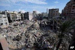 Palestinians search for the bodies of the al Meghari family killed in the Israeli bombardment of the Gaza Strip in Bureij refugee camp, Gaza Strip, Nov. 14, 2023.