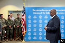 U.S. Secretary of Defense Lloyd Austin, right, speaks to employees of the U.S. embassy in Kyiv, Nov. 20, 2023.