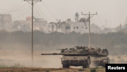 Israeli tanks re-enter Israel from Gaza near the Israel-Gaza border in southern Israel, Jan. 11, 2024. 