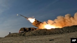 In this photo released by the Iranian Army on Jan. 19, 2024, a missile is launched during a military drill in southern Iran. 