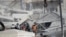 Emergency services work at a building hit by an air strike in Damascus, Syria, Jan. 20, 2024. Syrian and Iranian state media say an Israeli strike on the Syrian capital killed five Iranian advisers. 