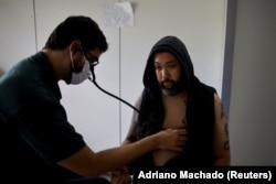 After testing positive for dengue, Nelson Diego receives treatment at a medical care unit in a neighborhood of Brasilia. Jan. 23, 2024. (REUTERS/Adriano Machado)