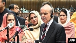 This handout photograph taken and released on March 3, 2024 by the Pakistan National Assembly, shows Pakistan's newly-elected Prime Minister Shehbaz Sharif (2R) addresses the Parliament in Islamabad. (Photo by Pakistan National Assembly / AFP) 