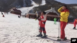 FILE - A mother and her daughter take a rest on the slopes at the Masik Pass ski resort in North Korea on Jan. 28, 2018. 