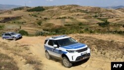 FILE - Cars of the European Border and Coast Guard Agency (FRONTEX) patrol at the Greece-Albania border, Sept. 4, 2019.