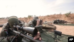 This image from video posted by Hamas on Dec. 20, 2023, purports to show Hamas militants using domestic copies of the AM-50 Sayyad, an Iranian-made a rifle that fires a .50- caliber round powerful enough to punch through up to an inch of steel.