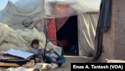Children rest outside a makeshift camp in Rafah, Gaza, March 2, 2024. Roughly 17,000 children have been separated or lost their parents in Gaza.