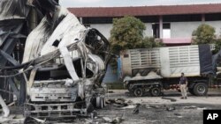 FILE - A Thai officer stands beside a burned-out oil tanker at a gas station in Pattani province, southern Thailand, Aug. 17, 2022. Thailand’s southernmost provinces have been the scene of an active Muslim separatist insurgency for almost two decades. 