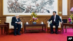 In this photo released by Xinhua News Agency, Chinese President Xi Jinping, right, talks to former US Secretary of State Henry Kissinger during a meeting at the Diaoyutai State Guesthouse in Beijing, July 20, 2023.