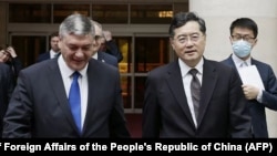 Russia's deputy foreign minister Andrey Rudenko, left, and China's Foreign Minister Qin Gang walk together as they meet in Beijing, June 25, 2023.