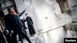 Britain's Foreign Secretary David Cameron visits the Transfiguration Cathedral damaged by a Russian strike earlier this year, in Odesa, Ukraine, in this handout picture released Nov. 16, 2023. (Press Service of Ukraine's Foreign Ministry via Reuters)