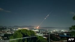 This long exposure picture taken late on Oct. 28, 2023 shows a missile fired from a Myanmar military base in Lashio township, northern Shan State. Heavy fighting between rebels and the military stretched into a second day near the northern border with China, armed groups said.