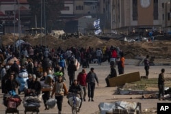 Palestinians flee an Israeli ground offensive in Kahn Younis, Gaza Strip, Jan. 27, 2024.