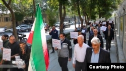FILE - Iranian Jews in Isfahan walk in a procession holding signs in Persian and English denouncing Israel's war against Hamas, Oct. 30, 2023. (Credit IRNA)