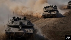 Israeli tanks head toward the Gaza Strip border in southern Israel on Oct.13, 2023.