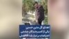 اهدای گل متین حسنی یکی از آسیب‌دیدگان چشمی اعتراضات بر مزار یلدا آقافضلی