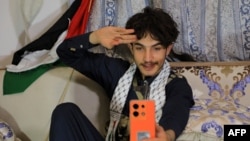Rashed Al-Haddad, 19, a Yemeni TikToker and influencer, who has been dubbed 'Tim Houthi Chalamet' by Western internet wags for his resemblance to actor Timothee Chalamet, talks to a friend on the phone in Sanaa on Jan. 18, 2024.