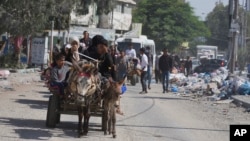 Palestinians flee northern Gaza after the Israeli army issued an evacuation warning telling the more than 1 million people in northern Gaza and Gaza City to seek refuge in the south before what many fear could be an Israeli ground invasion, Oct. 13, 2023.