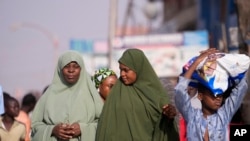 Women wait in Kaduna, Nigeria, March. 8, 2024. Security forces swept through large forests in Nigeria's northwest region Friday in search of nearly 300 abducted children.