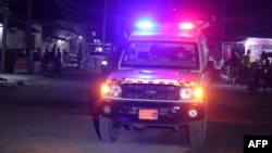 An ambulance is seen outside the perimeter of rescue operations in Mogadishu on June 9, 2023, during an attack. Rebels from the Islamist al-Shabab group were attacking a hotel in the city, the government and witnesses said.