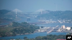 A cargo ship waits near the Centennial Bridge for transit through the Panama Canal locks, in Panama City, Jan. 17, 2024. A severe drought has forced authorities to slash ship crossings by 36% in the Panama Canal.