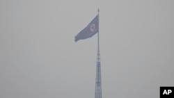FILE - A North Korean flag flutters in the wind atop a tower in North Korea's village Gijungdong as seen from an observation post inside the demilitarized zone in Paju, South Korea, Feb. 7, 2023.