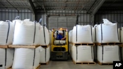 FILE - A worker moves bags of lithium carbonate at an Albemarle Corp. facility, Oct. 6, 2022, in Silver Peak, Nev. 