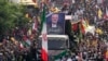 Iranians follow a truck carrying the coffins of Hamas leader Ismail Haniyeh and his bodyguard who were killed in an assassination blamed on Israel on Wednesday, during their funeral ceremony in Tehran, Iran, Aug. 1, 2024. 