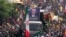 Iranians follow a truck carrying the coffins of Hamas leader Ismail Haniyeh and his bodyguard who were killed in an assassination blamed on Israel on Wednesday, during their funeral ceremony in Tehran, Iran, Aug. 1, 2024. 