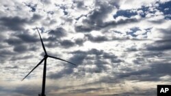 A Block Island Wind Farm turbine operates, Dec. 7, 2023, off the coast of Block Island, Rhode Island, during a tour of the North Fork Wind farm organized by Ørsted.