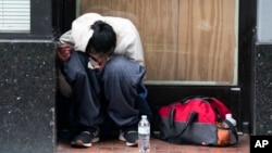 FILE - A person smokes fentanyl on April 12, 2023, in downtown Portland, Ore.