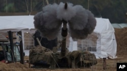 An Israeli mobile artillery unit fires a shell from southern Israel towards the Gaza Strip, in a position near the Israel-Gaza border , Jan. 14, 2024. 