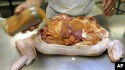 FILE - Glenn Mistich sprinkles seasoning on a turducken, a famous Louisiana specialty, at the Gourmet Butcher Block in Gretna, Louisiana, Nov. 20, 2005.