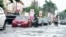 Cars drive on a flooded streets after a heavy downpour in Lagos, Nigeria, July 10, 2024. 