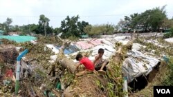 Rohingya refugee children in Cox’s Bazar, Bangladesh, create a makeshift playground amidst the ruins of their shelters after Cyclone Mocha. (Md. Jamal/VOA)
