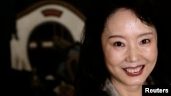 FILE - Author Yan Geling poses during an interview in Hong Kong, March 7, 2008. 