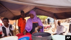 A woman prepares food in Niamey, Niger, on July 29, 2023. The European Union cut off financial support to Niger, one of the poorest countries in the world, following a coup there.